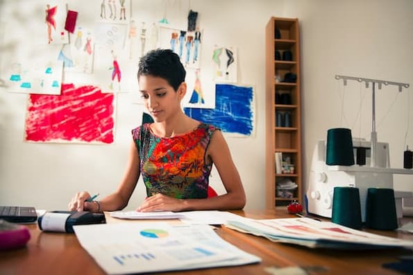 Woman at desk writing business case