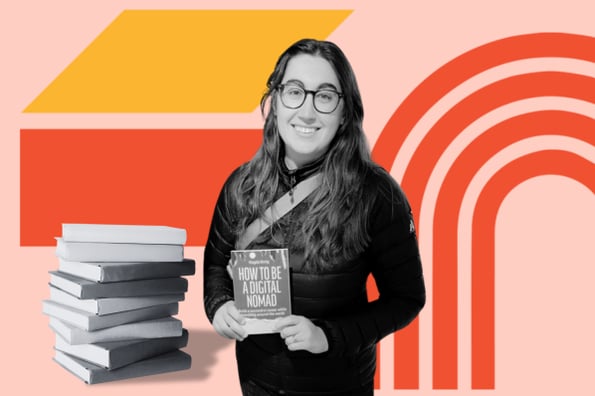 Woman displays book near bookshelf